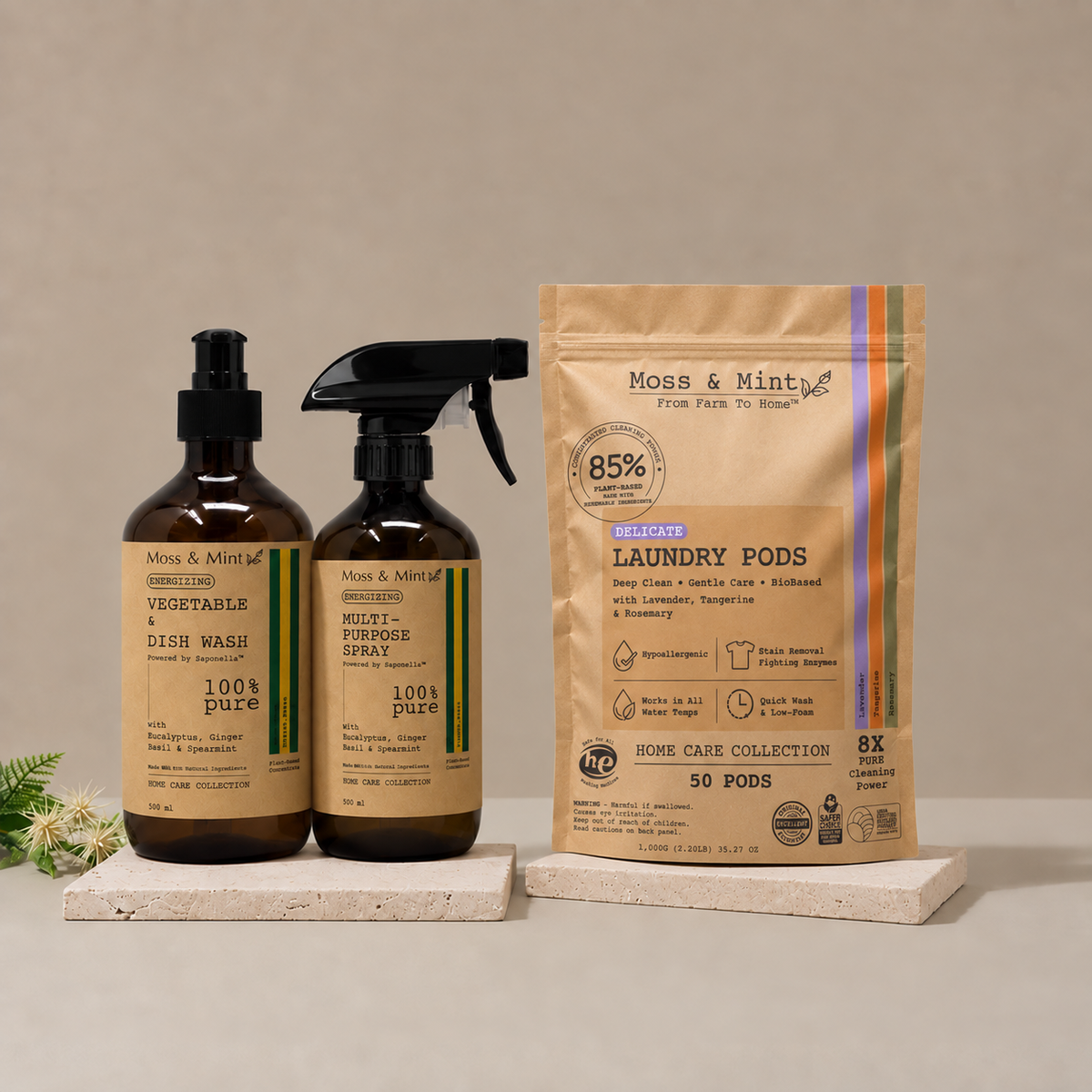 Moss & Mint vegetable and dish wash, multi-purpose spray and revised Delicate Laundry Pods 50-count pouch on stone trays.